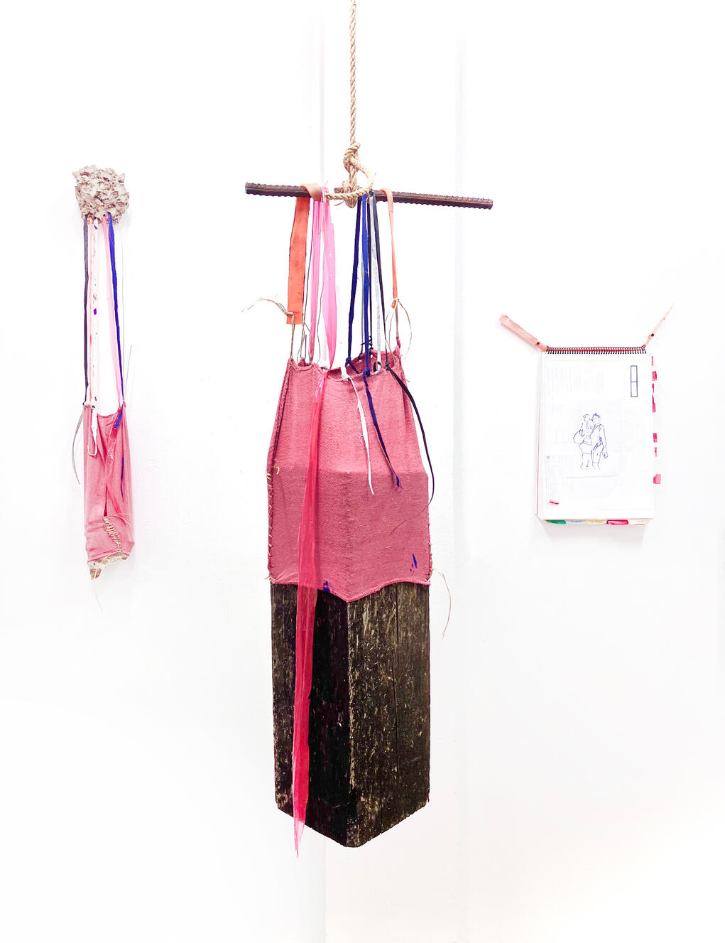 "Railroad Tie and Rag", 2024, wood, tarp, shop rag, sinew, wire, tar paper, traffic cone, uniform, 17" × 80" × 8".